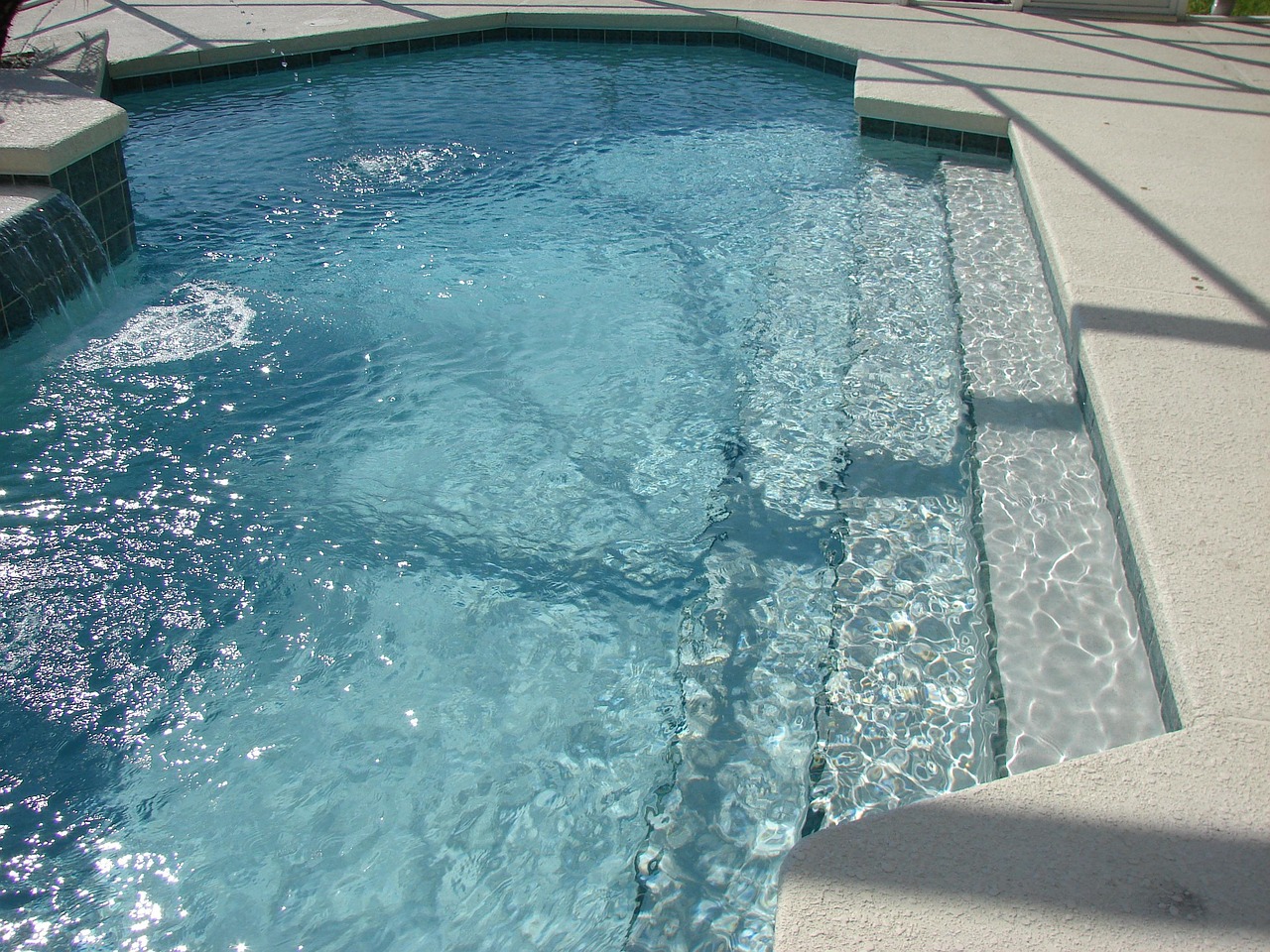 Crystal clear swimming pool with water feature